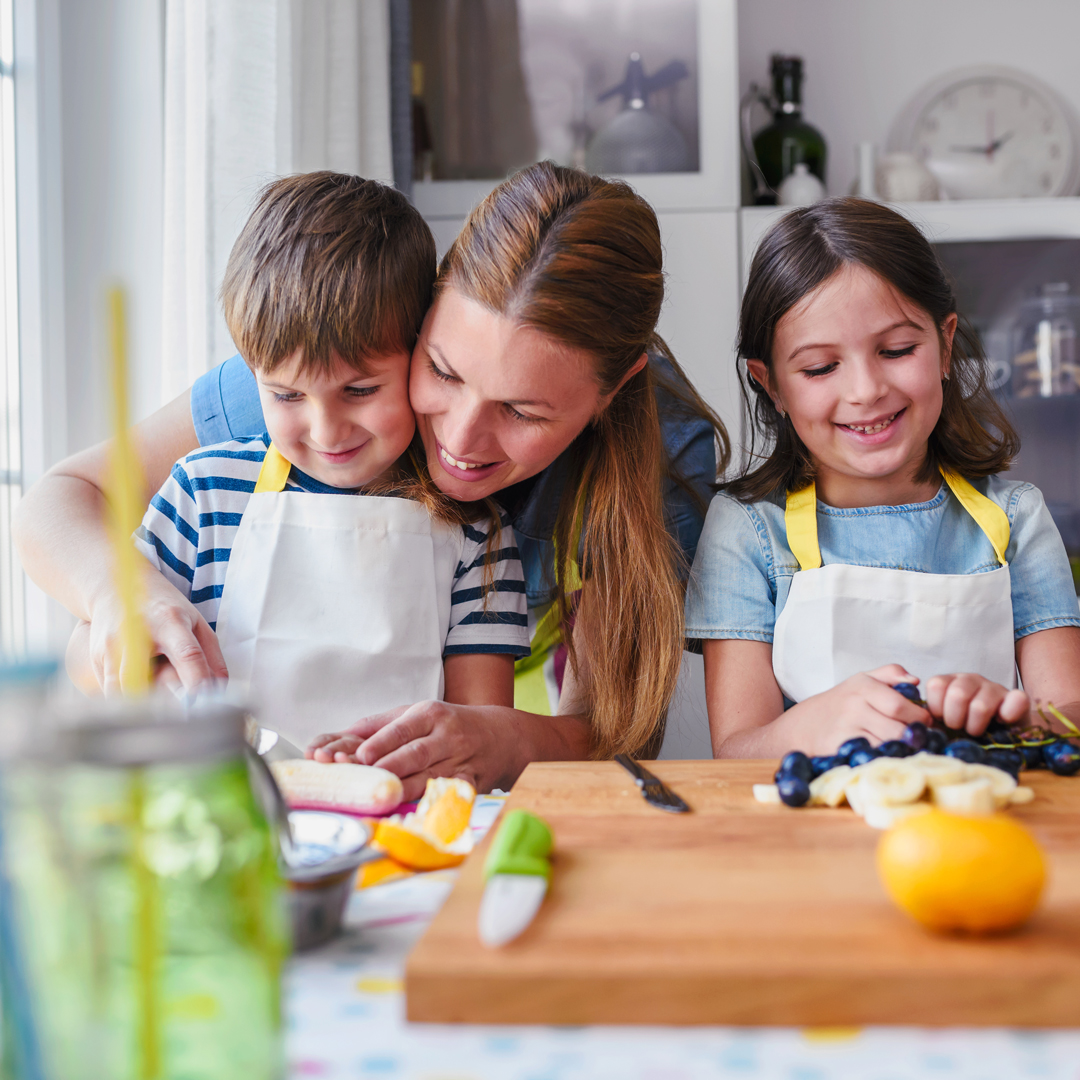 Mother and two children cooking in kitchen